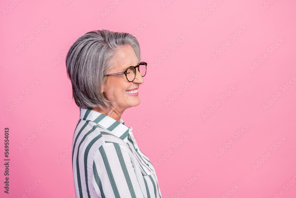 Side profile photo of funny laughing excited senior business manager woman smile wear glasses laughing joke isolated on pink color background