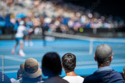 tennis fan watching a tennis match at the australian open eating food and drinking © William
