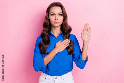 Photo of confident adorable lady wear blue stylish clothes showing arm promise love care appreciate isolated on pink color background photo