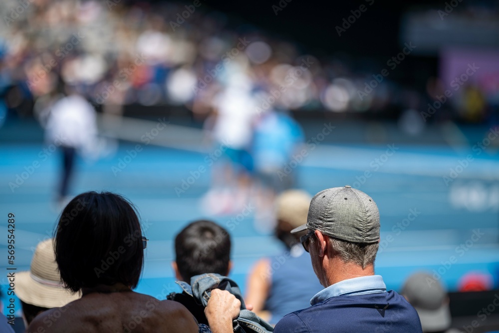 tennis fan watching a tennis match at the australian open eating food and drinking - obrazy, fototapety, plakaty 