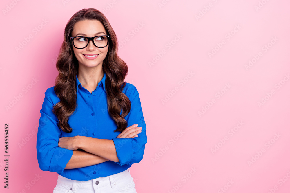 Portrait of gorgeous nice girl with wavy hairstyle wear blue shirt hold arms crossed look empty space isolated on pink color background Portrait of gorgeous nice girl with wavy hairstyle wear blue shirt hold arms crossed look empty space isolated on pink color background