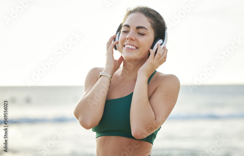 Headphones, fitness and happy woman on beach for wellness, mental health and audio streaming on mockup. Sound, psychedelic or meditation podcast of person listening to music for peace by ocean or sea