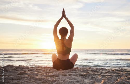 Woman  yoga and meditation on the beach sunset for zen workout or spiritual wellness outdoors. Female yogi relaxing and meditating in sunrise for calm  peaceful mind or awareness by the ocean coast