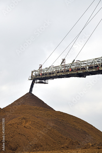 An huge excavator on a coal surface mine. Interesting geological forms of tailings dump in an open pit coal mine.