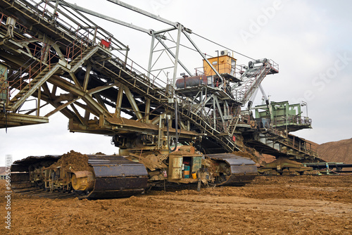 An huge excavator on a coal surface mine. Interesting geological forms of tailings dump in an open pit coal mine.