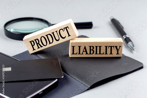 PRODUCT LIABILITY text on wooden block on black notebook , business concept photo