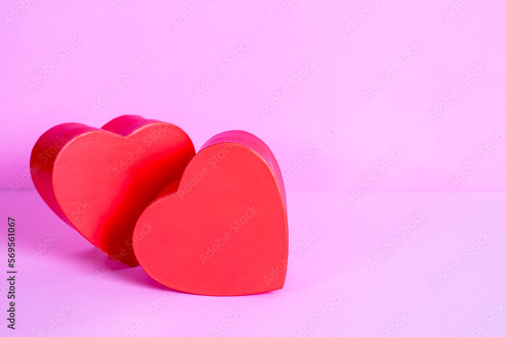 two red hearts in love on pink background