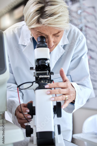 ophthalmology, microscope and glasses with a woman doctor with tools to check lens for eye care. Medical person at work for science, vision and health insurance while working in lab, store or clinic