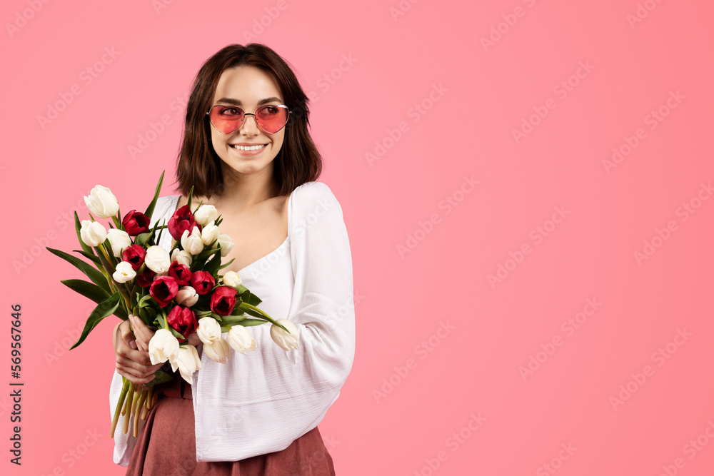 Smiling young european female in glasses with bouquet of flowers, enjoy lifestyle and rejoicing spring holiday Smiling young european female in glasses with bouquet of flowers, enjoy lifestyle and rejoicing spring holiday