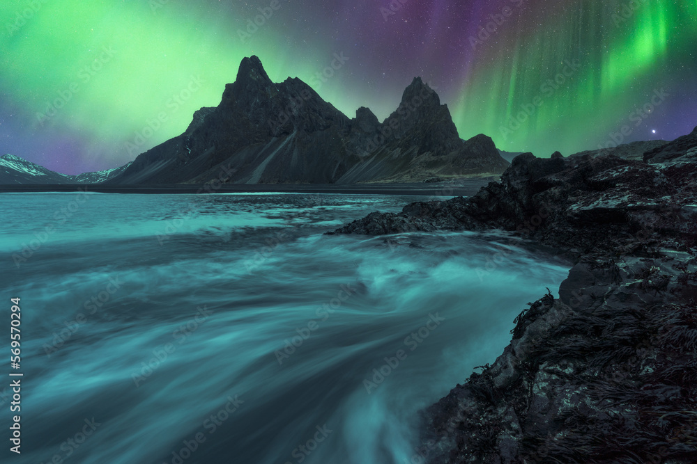 Picturesque view of black sand beach under sky with polar light Picturesque view of black sand beach under sky with polar light
