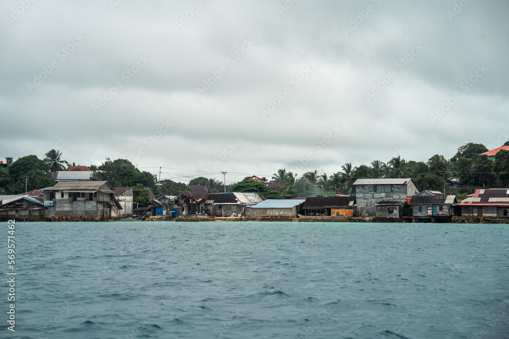 Scenic Riverside View of a Small Asian Town with Tin Huts and Pour Housing