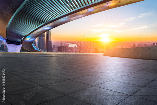 Empty square floor and bridge with city skyline at sunrise in Shanghai, China.