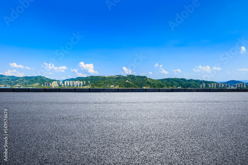 Empty asphalt road and green mountain nature scenery under the blue sky