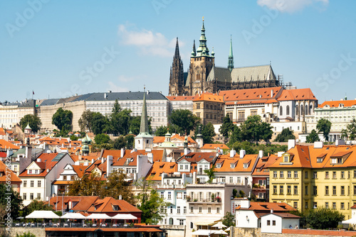 Prague Castle panorama, view from Smetanovo Waterfront over the Vltava river towards the Castle with Na kampe and other buildings in the foreground 