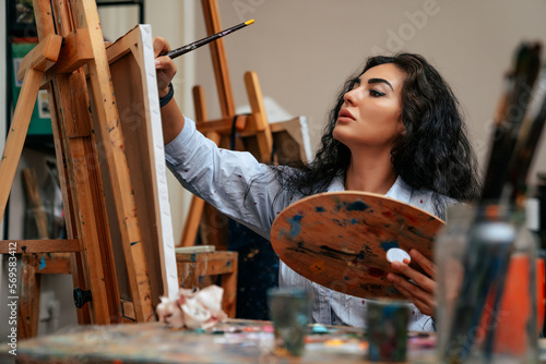 young artist working on a painting at the studio