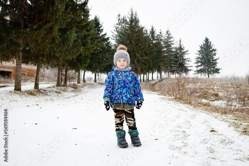 Happy kids running in beautiful winter forest or park photo