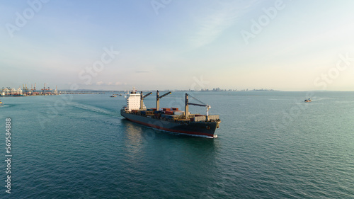 corgo ship container in sea and commercail port background. is a transport and distribution system to consumers and dealers marine in the current. aerial view