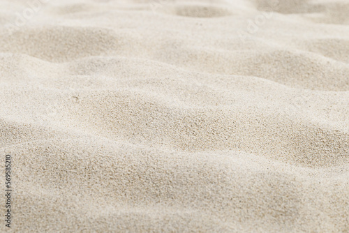 Fine Sand texture natural surface. Close up of sand on shore sea, white waves dunes, beige neutral color, minimal nature aesthetics wallpaper. Sandy beach for background, selective focus