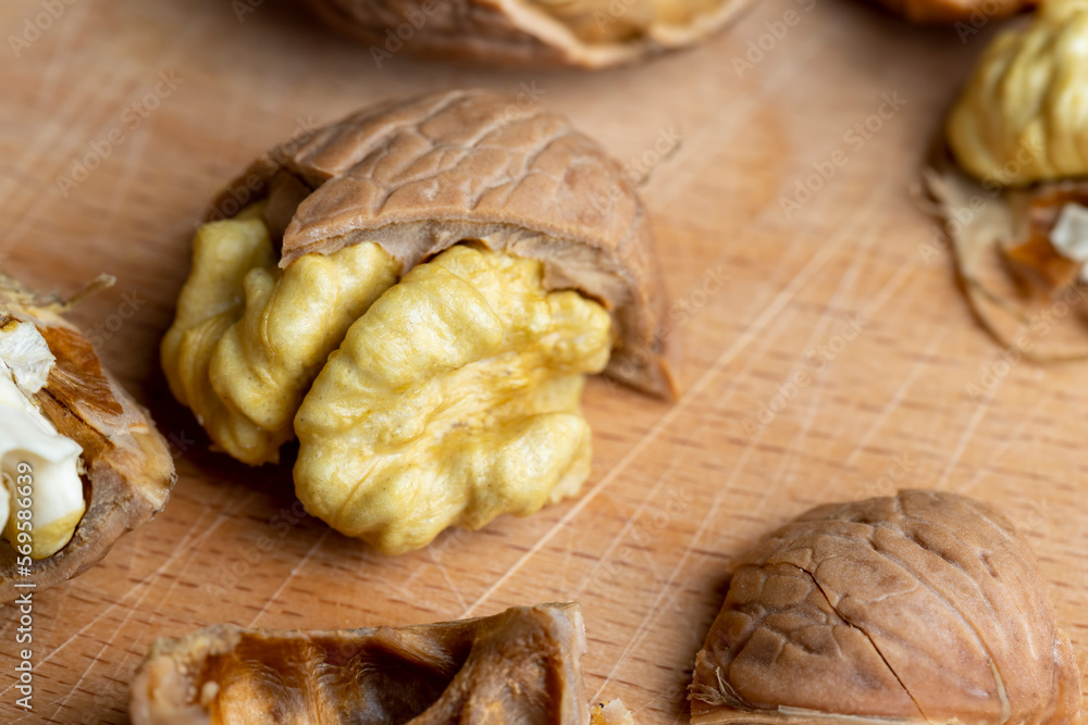 Open and broken walnut shells lying on the table Open and broken walnut shells lying on the table