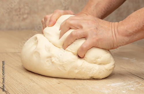 Hand kneading flour dough.