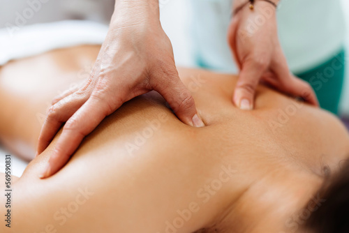 Wallpaper Mural Beautiful young adult brunette receiving professional relaxation massage treatment at beauty spa salon. Torontodigital.ca