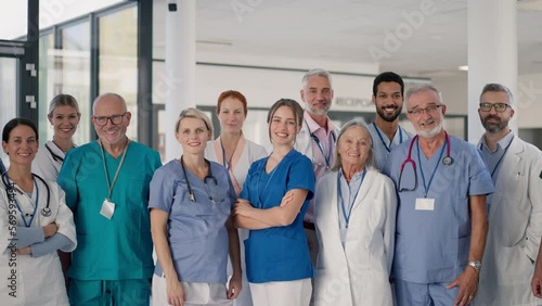 Happy doctors, nurses and other medical staff posing in hospital.