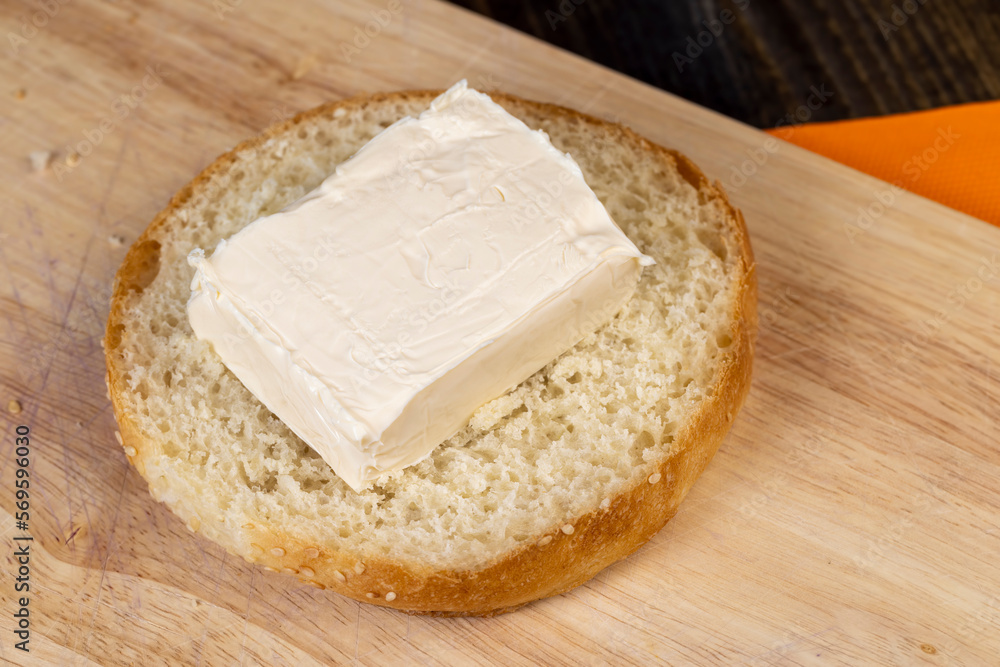 Wheat bun with large pieces of processed cheese inside Wheat bun with large pieces of processed cheese inside