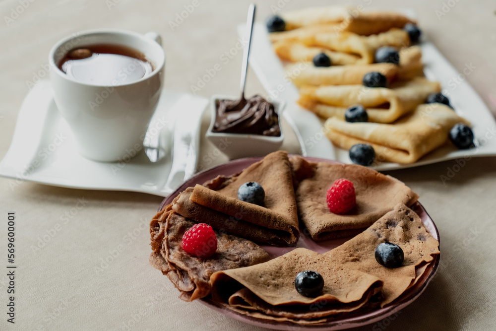 classic and chocolate pancakes with berries and fruits for breakfast, chocolate, tea, classic and chocolate pancakes with berries and fruits for breakfast, chocolate, tea,