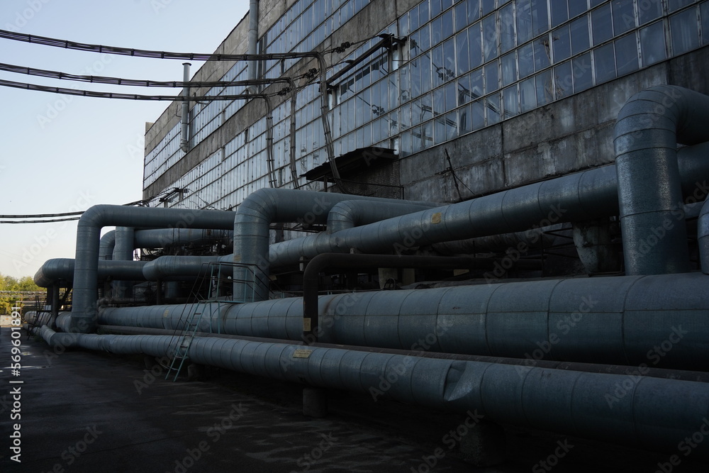 Almaty, Kazakhstan - 10.07.2022 : Large pipes on the territory of the heating plant and electrical substation. Almaty, Kazakhstan - 10.07.2022 : Large pipes on the territory of the heating plant and electrical substation.
