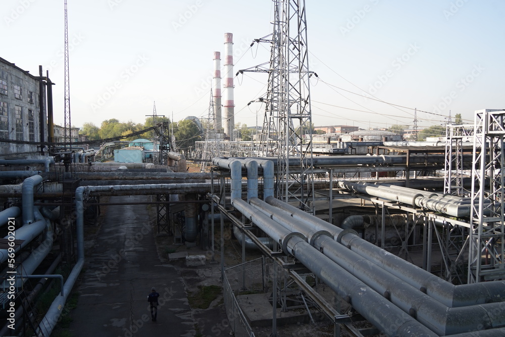 Almaty, Kazakhstan - 10.07.2022 : Large pipes on the territory of the heating plant and electrical substation. Almaty, Kazakhstan - 10.07.2022 : Large pipes on the territory of the heating plant and electrical substation.