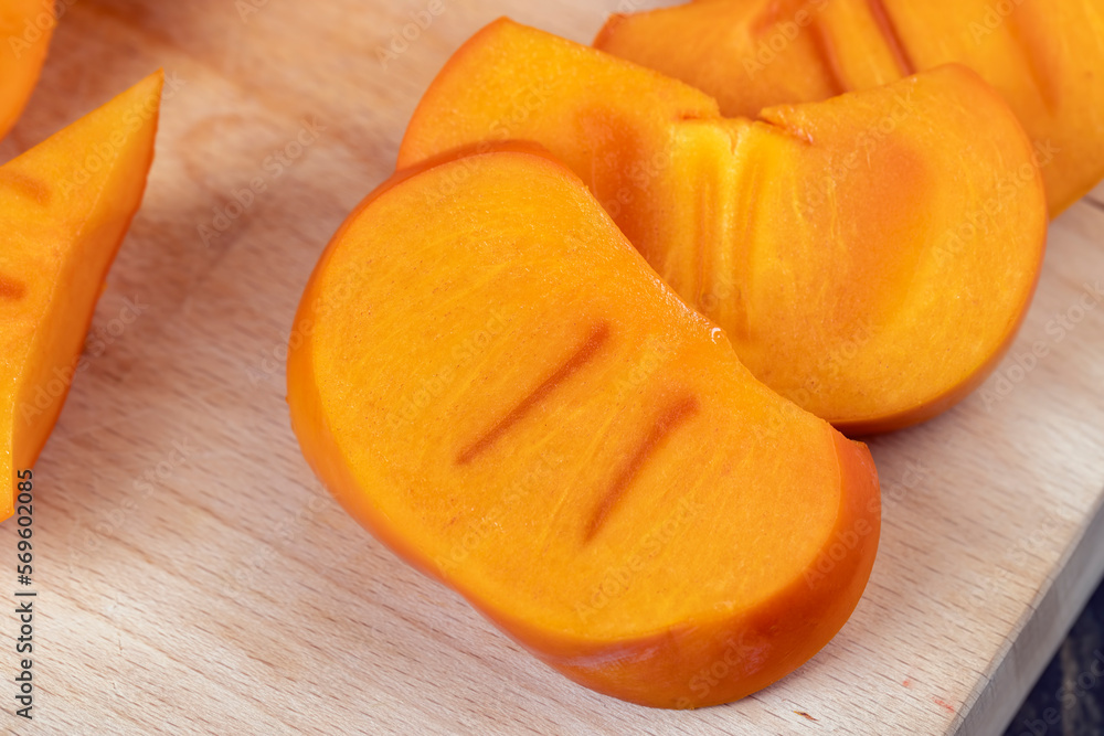 Sliced ripe orange pitted persimmon