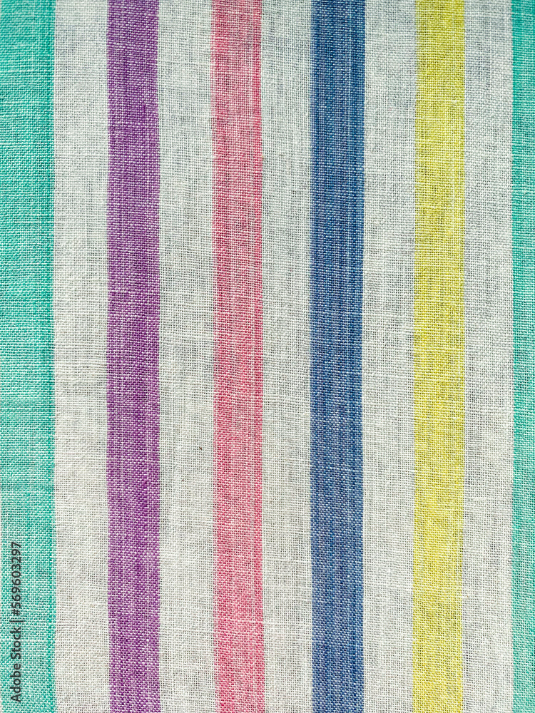 Fototapeta premium The texture of the fabric. White sheet in multi-colored lines. Cotton, linen, calico. Striped background.