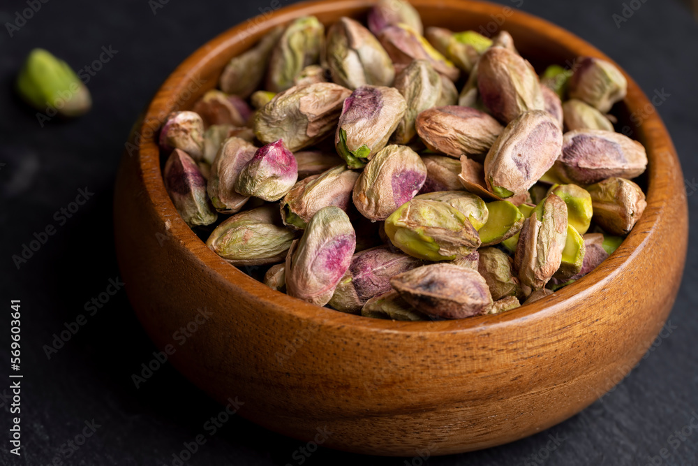 Crispy delicious pistachios with salt on the table Crispy delicious pistachios with salt on the table