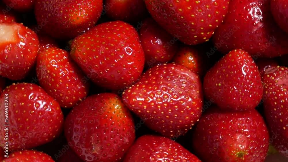 Red large ripe strawberries closeup background. Harvest berries., rotating Red large ripe strawberries closeup background. Harvest berries., rotating
