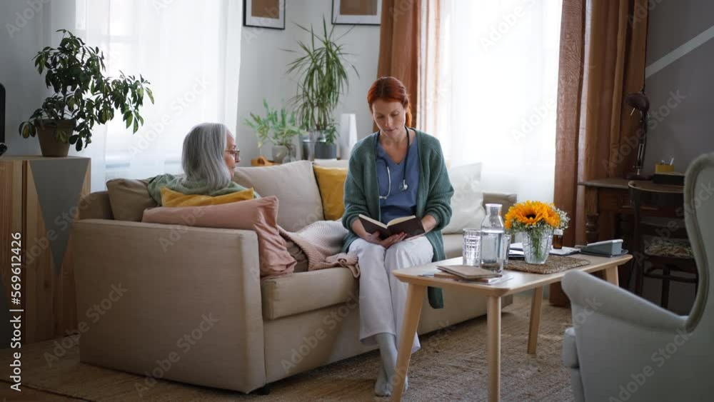 Nurse reading a book to senior woman. Nurse reading a book to senior woman.