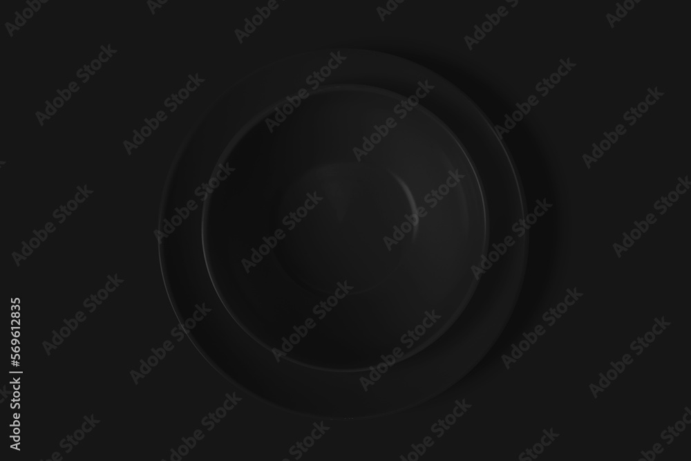 Two black plates on a black background. View from above. Concept Two black plates on a black background. View from above. Concept