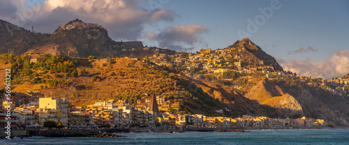 View of Castelmola, Taormina and Giardini Naxos viewed from Giardini Naxos beach, Sicily, Italy, Mediterranean, Europe photo