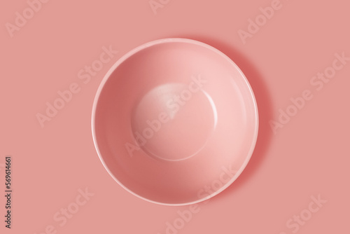 Pink plate on a pink background. View from above. Concept