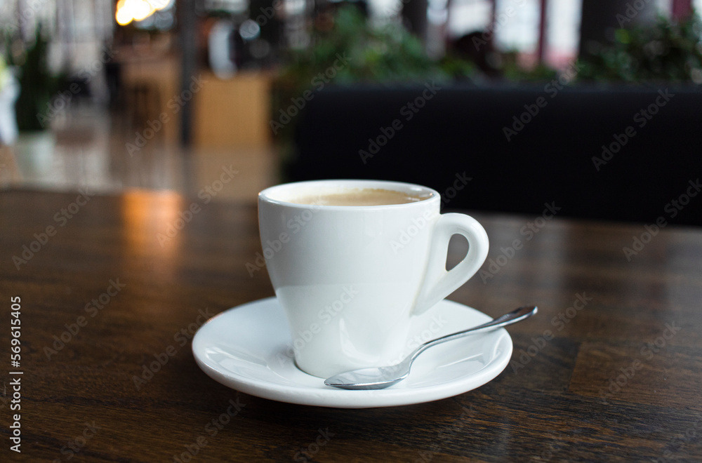 Close up white cup of coffee latte on wood table in cafe Close up white cup of coffee latte on wood table in cafe