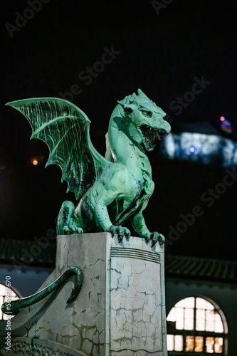 Dragon bridge and the Dragon statue with the Ljubljana castle at night