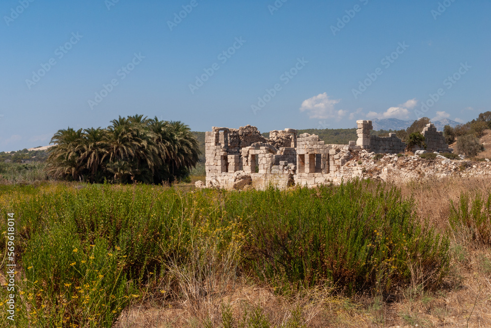 Ruins of ancient Roman temple. Temple of huge stones. Turkey. Historical landmark. Automobile road. Close-up. Mountain landscape. Clear sunny September day. Ruins of ancient Roman temple. Temple of huge stones. Turkey. Historical landmark. Automobile road. Close-up. Mountain landscape. Clear sunny September day.