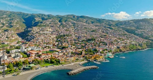 Aerial top view cityscape town on the coast and mountains around of Funchal the largest city the municipal seat and the capital of Portugal's autonomous region of Madeira island in the Atlantic Ocean. photo
