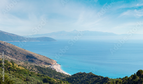 Adriatic sea summer coast with beach and Corfu island in mist (Lukove komuna, Albania). View from mountain pass.