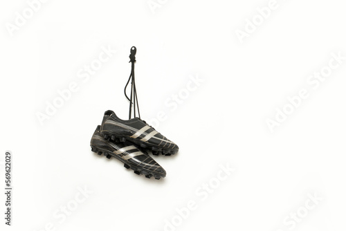 soccer spikes are hanging against white background