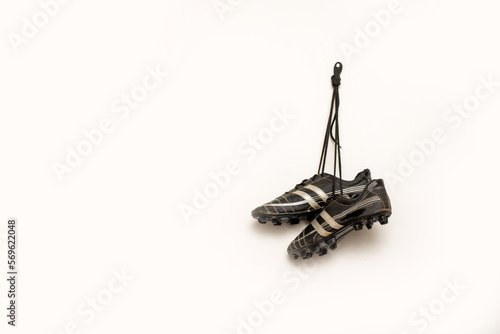 soccer spikes are hanging against white background