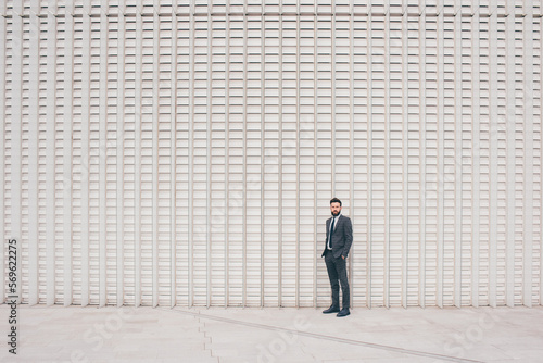 Confident and professional elegant bearded businessman standing outdoor posing contemplating