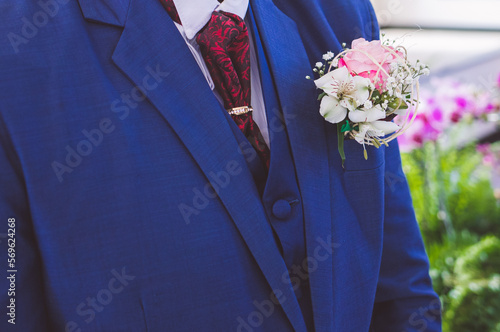 man dressed in a suit, taped and a flower lapel