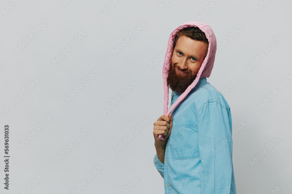 Funny man in a pink hat portrait on a light gray background. Smile and positive emotions. Funny man in a pink hat portrait on a light gray background. Smile and positive emotions.