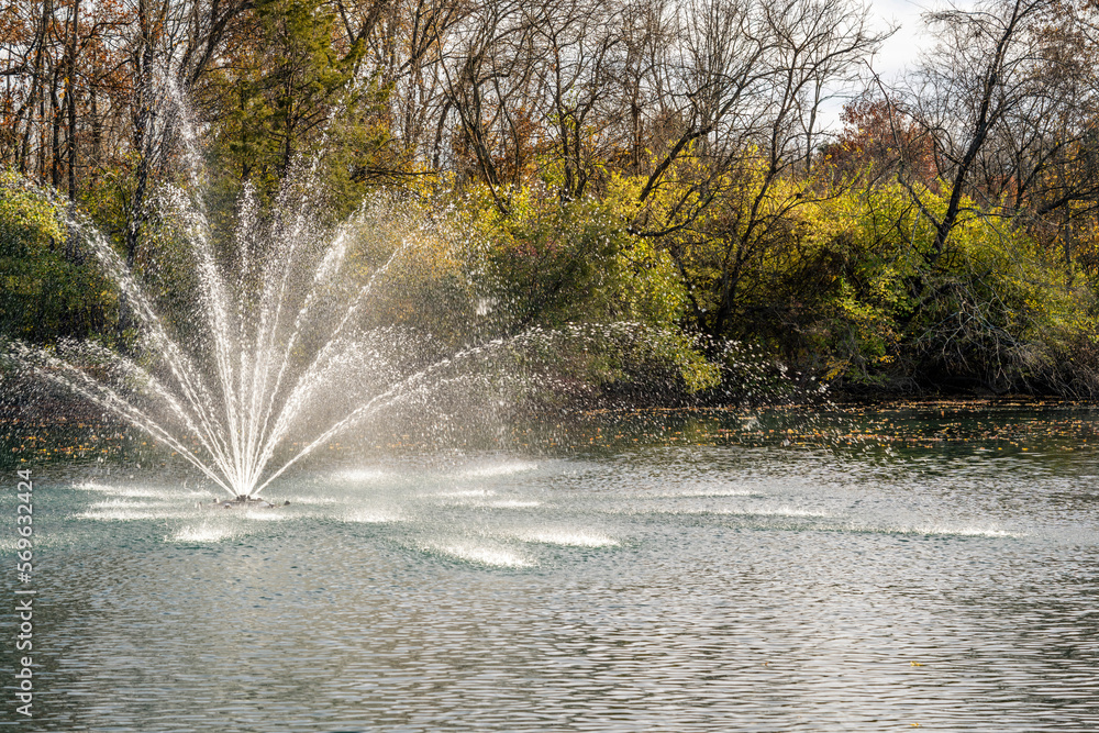 Pond fountain in autumn fall time Pond fountain in autumn fall time