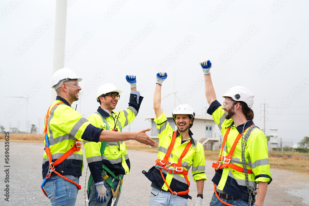 Wide perspective of wind turbine engineers walking with coworker in wind farms Wide perspective of wind turbine engineers walking with coworker in wind farms